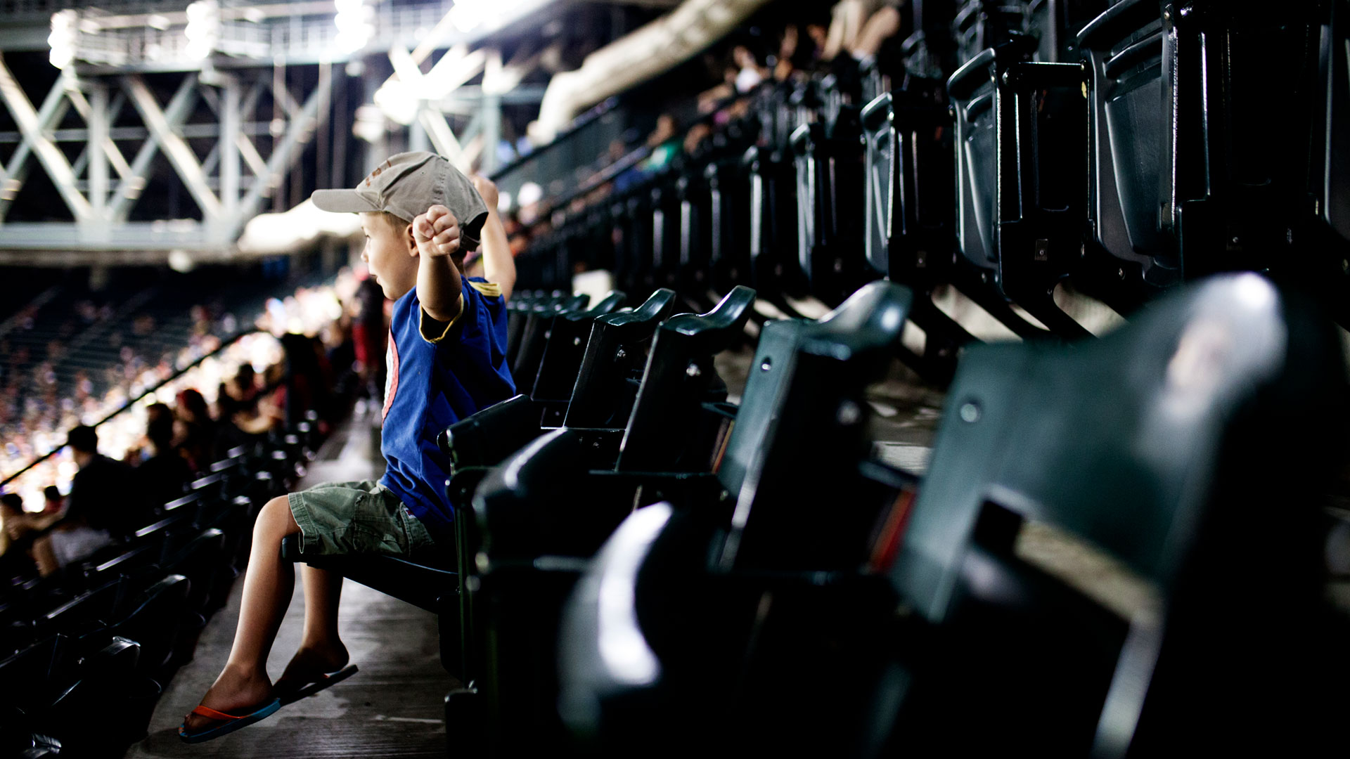 An excited child sitting in the stands at a baseball game